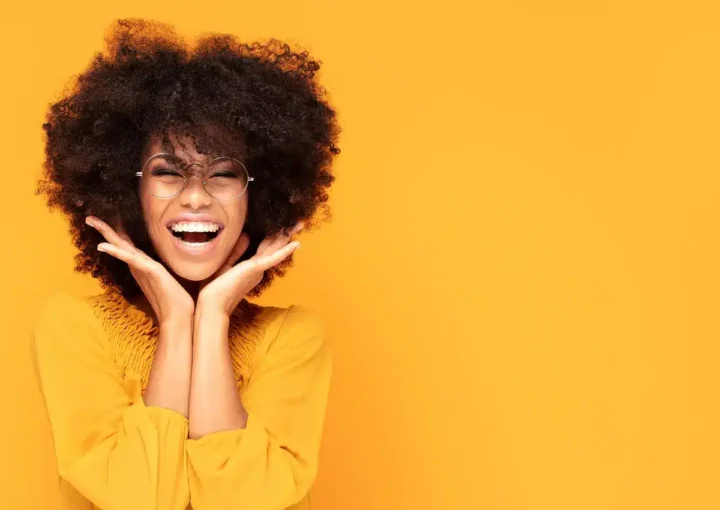 Woman smiling with yellow background