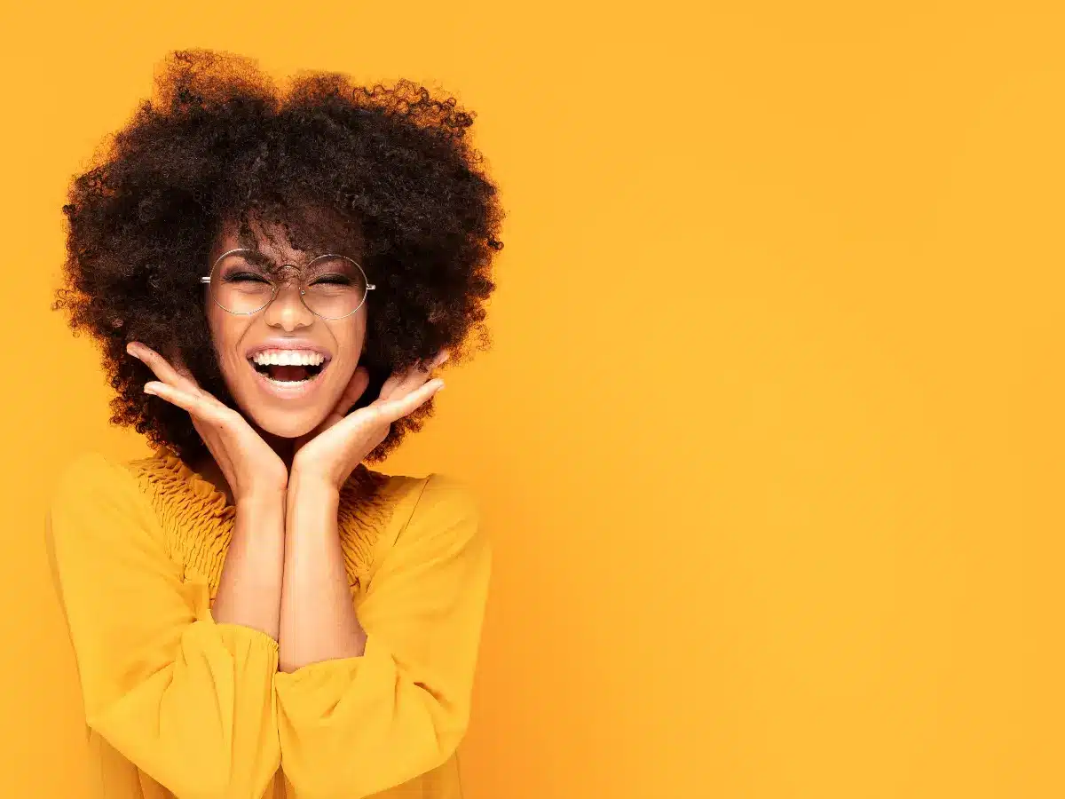 Woman smiling with yellow background