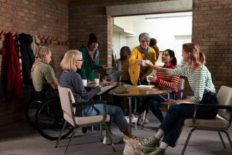 carers groups showing people sitting around table with tea
