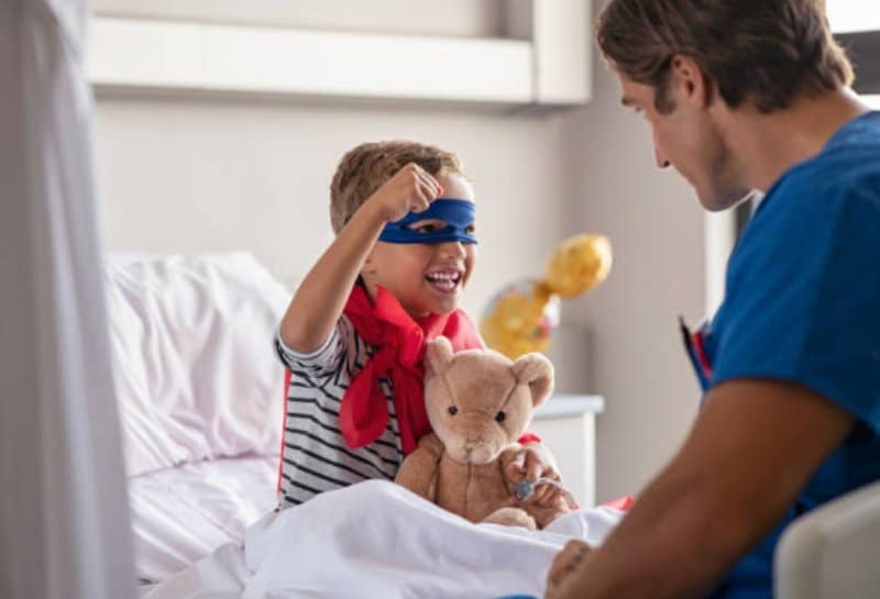 child in hospital dressed as superman